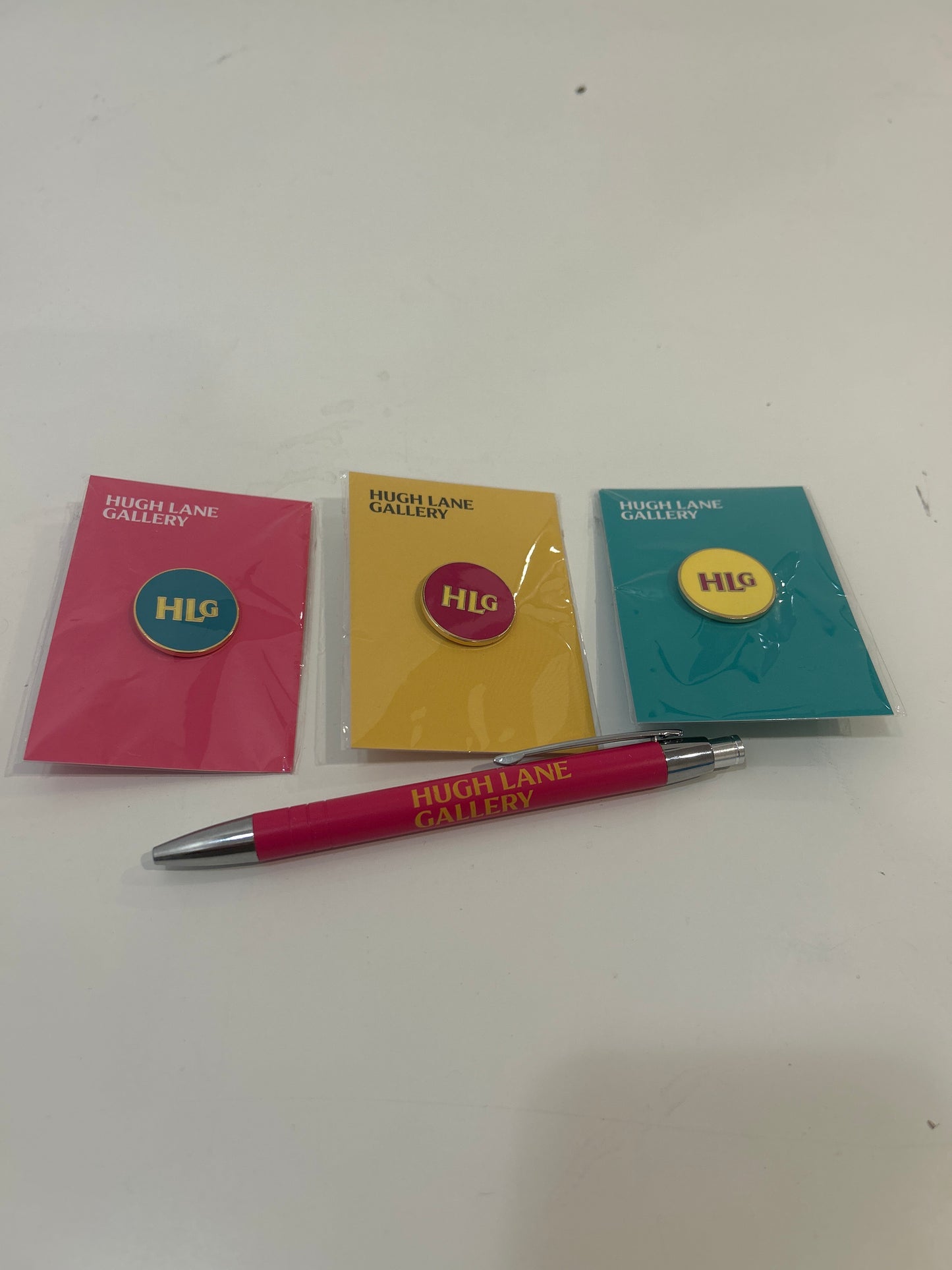 HUGH LANE GALLERY TEAL PIN WITH PINK BACKING CARD